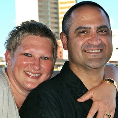 Happy couple embracing each other in a hug.